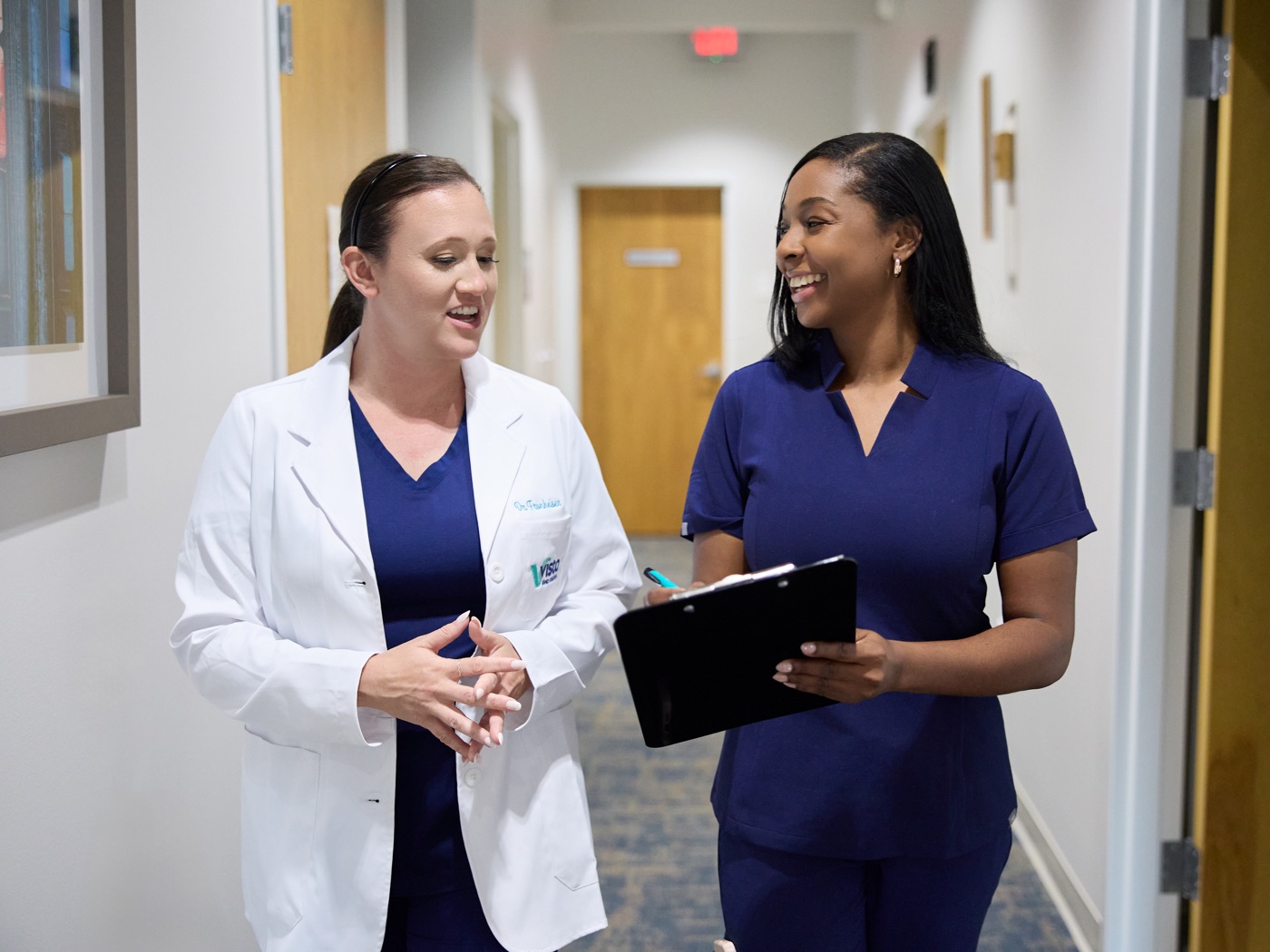 Dr. Rebecca and a team member talking at Vista